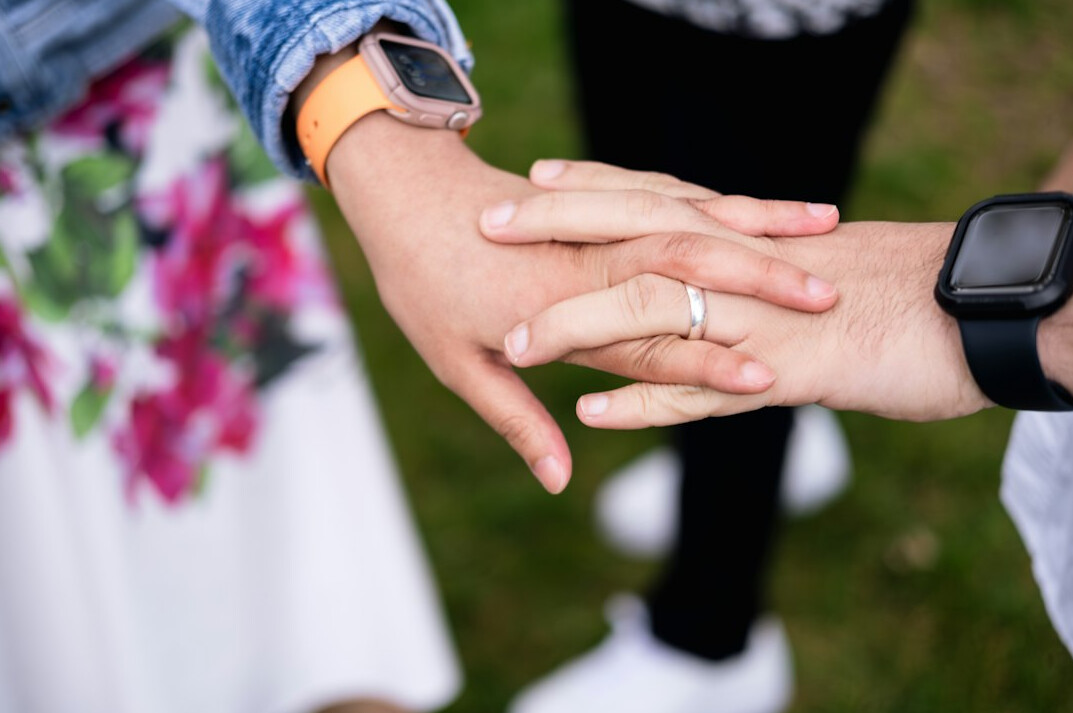 Business partners shaking hands across a table